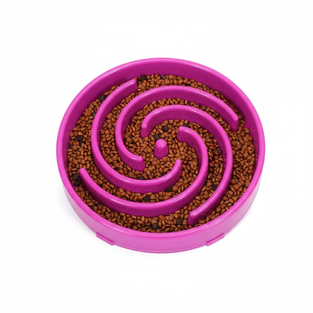 Purple slow feeder dog bowl with spiral design and kibble.